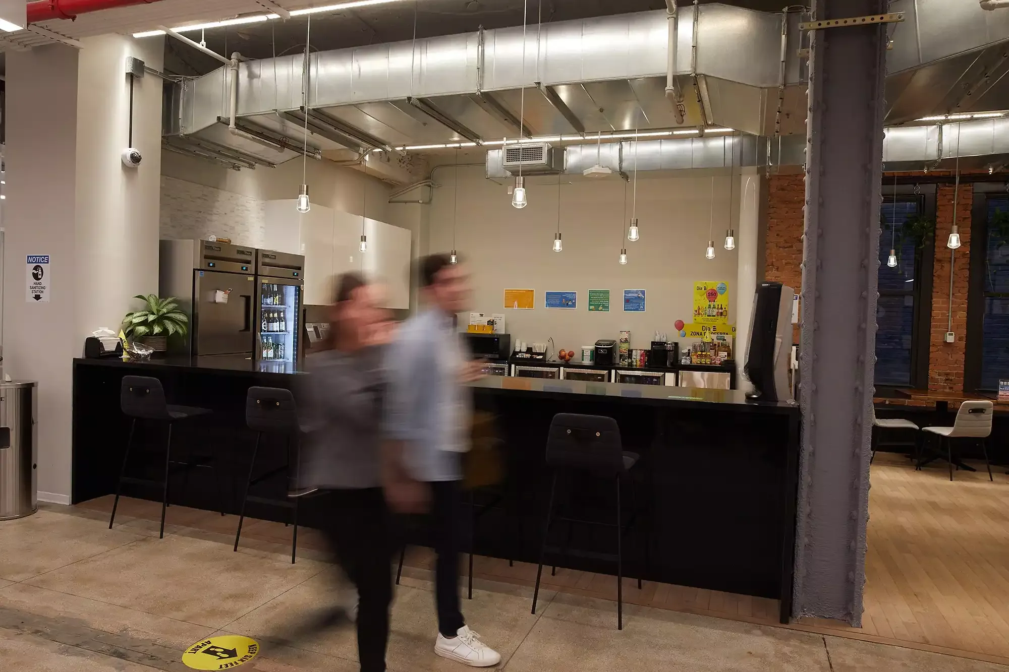 Two people walking in a bar